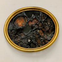 a gold framed painting with a black background